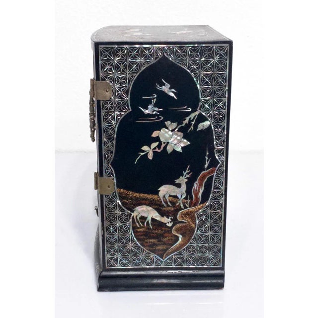 Splendid antique Chinese black lacquer jewelry box with exquisite workmanship. Intricate mother of pearl inlay with...