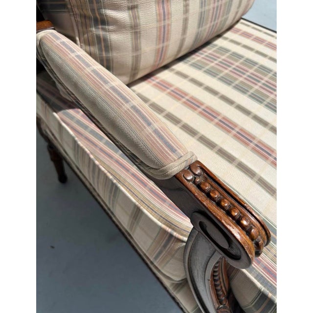 Charming room piece made of wood and upholstery. This oversized French style armchair features carved wood, striped...