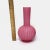This antique Victorian velvet ribbed pink satin art glass vase is in good condition with some small chips as pictured.