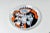 Pair of glazed ceramic plates by Franco Pozzi, Italy, dated 1965. Bold graphic decoration with a comic-strip sensibility...