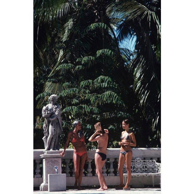 Bikinis In Haiti 1975 Marni Morrell and Denise Schluscer with a third woman, all wearing bikinis, pose beside a statue on...