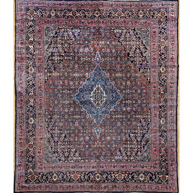 An early 20th century room-size hand-knotted Persian Bibikabad rug featuring the classic Herati geometric pattern set...