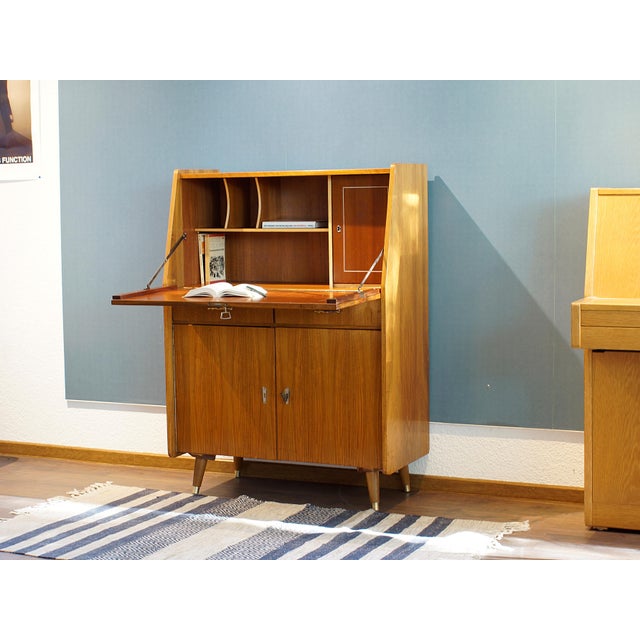 Stylish secretary desk from the late 1960s. The piece shows signs of age and use. It has been cleaned, and minor...