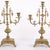 Pair of French bronze candlesticks from the 1890s. Three-armed design with ornate decoration and fine detailing typical of...