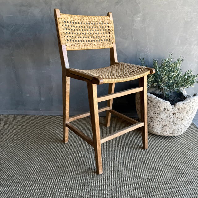 Enhance your indoor / outdoor dining experience with this stylish solid teak wood counter stool featuring a wipeable woven...