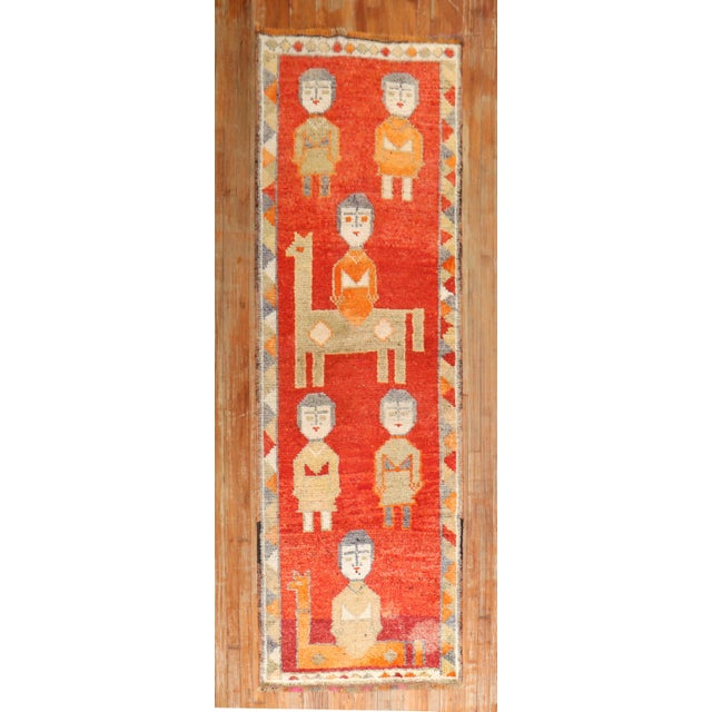 A decorative one of a kind colorful mid 20th-century Turkish runner featuring 6 humans and 2 animals Measures: 3'1'' x 9'4''