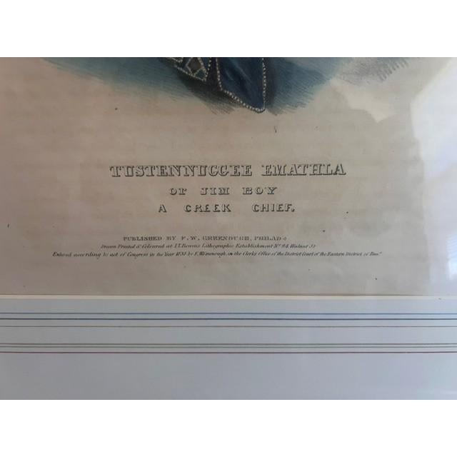 This is a hand-colored lithograph portrait of Tustennuggee Emathla, also known as Jim Boy, a prominent Creek Chief. It is...