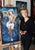 This artwork depicts a figure gracefully poised against a tumultuous sea, where dynamic waves swirl in shades of blue and...