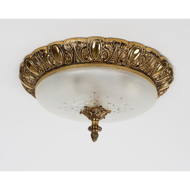 A vintage flush mount 3-light fixture made of brass with a frosted glass patterned lampshade. Spain circa 1960s....