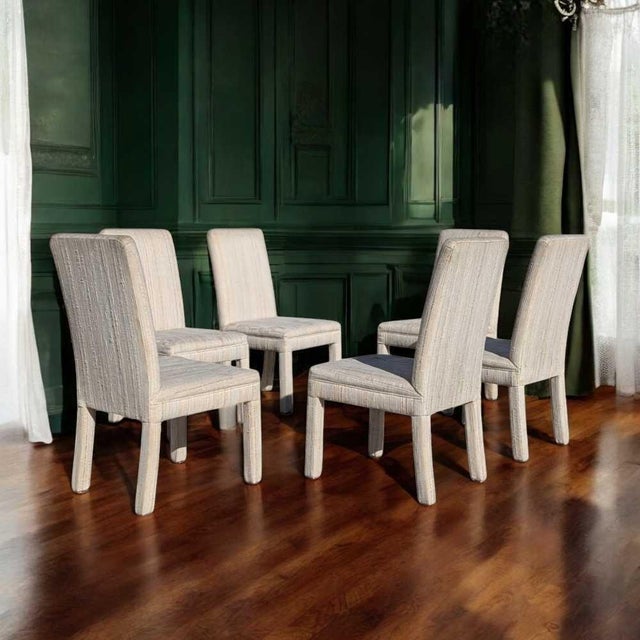 A striking set of six Postmodern dining chairs from the 1980s, featuring a bold, sculptural silhouette and upholstered in...