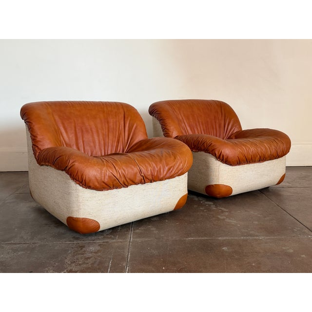 Elegant pair of vintage Italian “Swan” chairs from the 1970s, defined by their sculptural, curved silhouettes and refined...