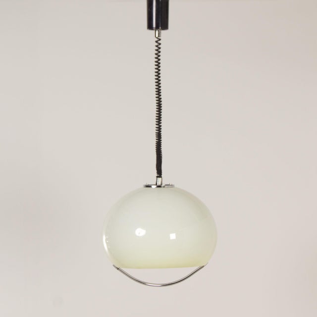 Guzzini hanging lamp “Jolly” designed by Luigi Massoni for Harvey Guzzini in 1968. This seventies pendant has a pull...