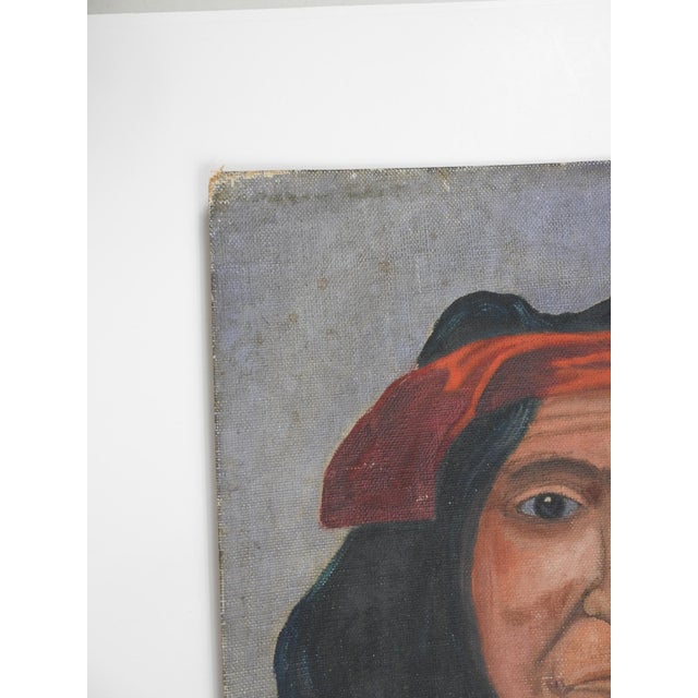 Early 20th century oil on canvas board folk art portrait painting of Native American in green shirt red robe and tuquoise....