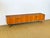 Elegant low scandinavian/vintage teak sideboard from the 1960s. with its minimalist lines, sculpted cubic handles, and...