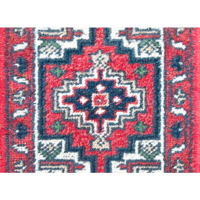 A charming petite late 20th century Persian Hamadan rug with a central geometric patterned medallion surrounded by a...