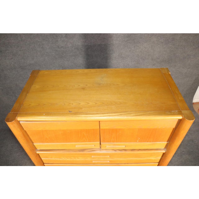 Tall standing dresser in teak by Thomasville Furniture. Four wide drawers and cabinet storage. No maker's mark