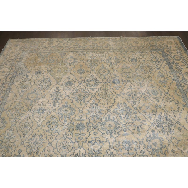 A 1910s Chinese Peking rug with an all-over geometric design in blues, creams, and tans