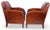 It is my pleasure to present an exceptional pair of early French leather club chairs. These charming armchairs are adorned...