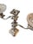 This stunning candlestick holds three candles. It features two arms, each topped with a glass bobeche. There is botanical...