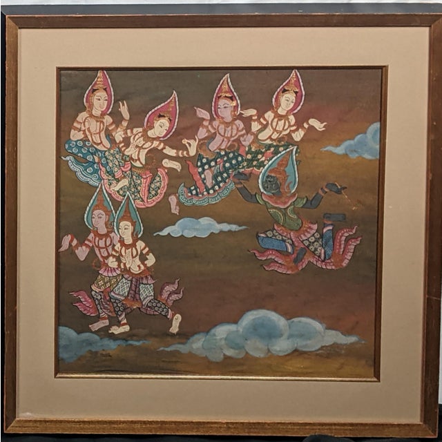 An elegant pair of Thai-style paintings on fabric depicting elaborately dressed celestial figures in richly ornamented...
