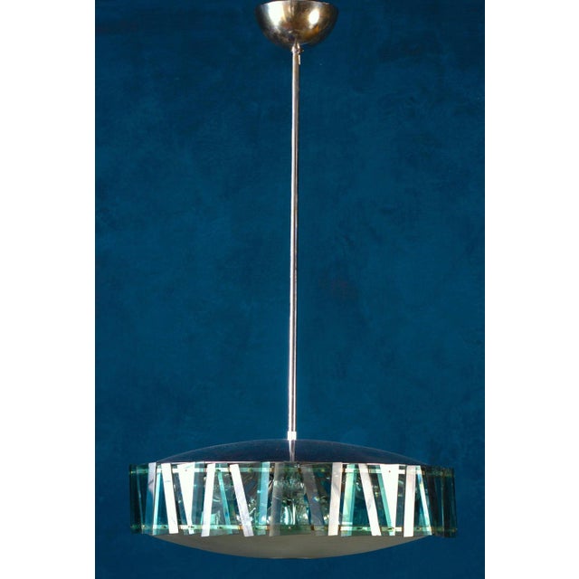 Elegant Minimalist chandelier attributed to Max Ingrand for Fontana Arte, with a frosted glass bowl surrounded by amazing...
