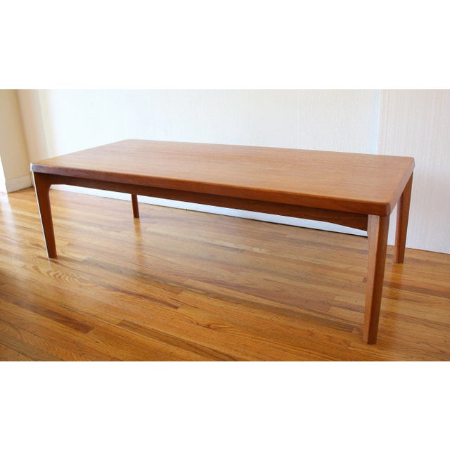This is mid century modern Danish teak coffee table designed by Henning Kjærnulf for Vejle Stole Mobelfabrik. It has a...