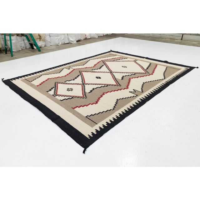 Elevate your space with this stunning Modern Navajo-style wool rug, featuring a sophisticated fusion of traditional motifs...