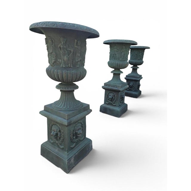 Impressive set of four monumental garden urns crafted in iron and finished with a beautiful green patina. Made in Italy...