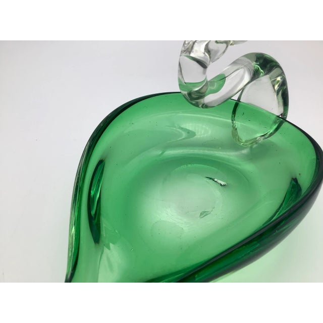 A sweet vintage decorative green and clear glass bird. The glass bird in really good condition, with a minor chip on the...