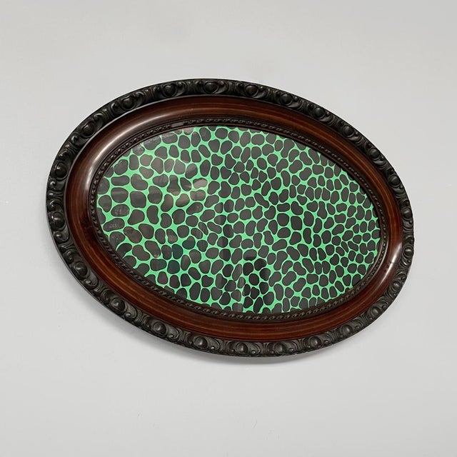 Italian modern picture with wooden frame and formica, 1940-1980s Framed piece with a decorative dark wood oval frame....