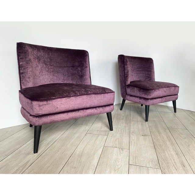 A unique pair of french-style armchairs with extra-large seats. Made entirely of purple velvet with matching dark purple...
