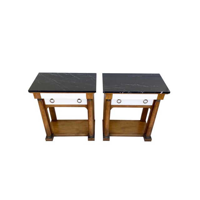 A masculine pair of Neoclassical bedside or side tables from Baker Furniture's "Palladian Collection." Clean-lined...