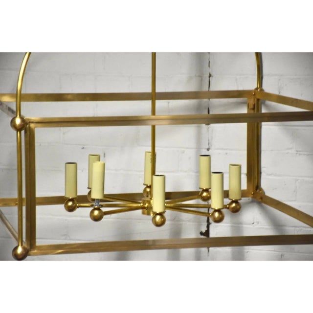 A stunning Chapman and Myers lantern chandelier from Visual Comfort in antique brass. 29” wide. 29” deep. 23” tall.