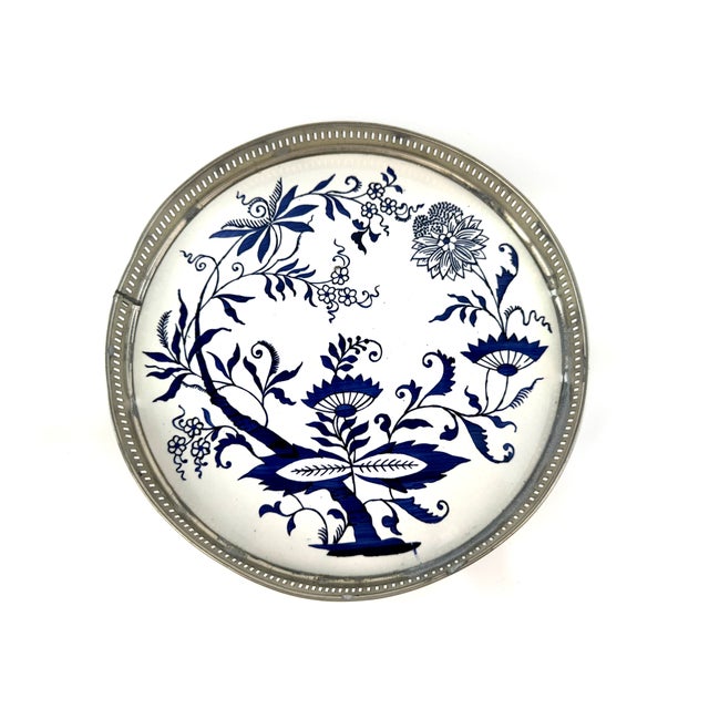 A charming vintage barware set featuring a central porcelain tray and seven matching coasters, each framed in pierced...