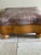 Western style distressed leather ottoman with nailhead trim on a solid maple base with bun feet. Taupe leather, scalloped...