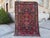 This is a vintage Kurdish Herki tribal rug, hand-knotted with wool and about 50 years old. It shows strong geometric...