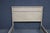 Whitewashed oak queen bed frame featuring clean paneled detailing, softly rounded edges, and tapered legs. Finished in a...