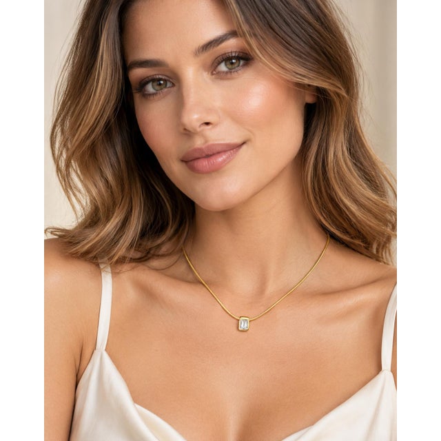 An authentic and elegant fine jewelry solitaire pendant necklace crafted in solid 14k yellow gold. Featuring a clean,...