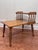 This is a vintage two tiered side table featuring a warm honey-toned finish on what appears to be solid wood maple....