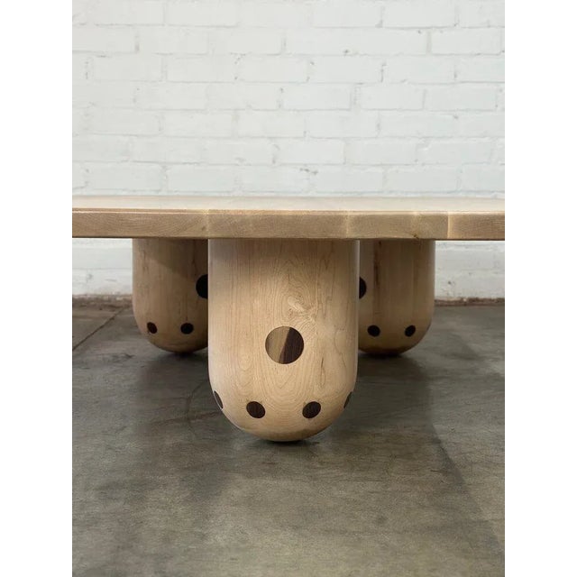 W56 D46 H18 Handcrafted in house in solid maple and walnut. Item features three removable rounded cylindrical legs with...