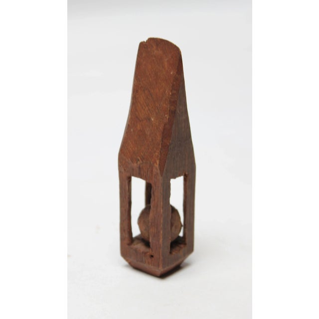 Circa 1910 trench art whimsy figure composed of a ball in cage, all whittled form one piece of wood. Figurines, like this...