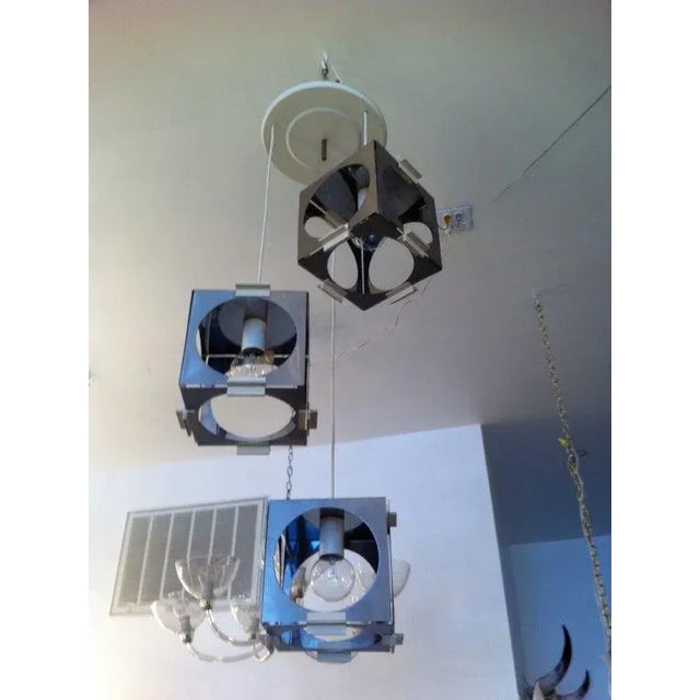 A great matte steel architectural three-light cubic pendant fixture. The cord can be adjusted shorter or longer based on...
