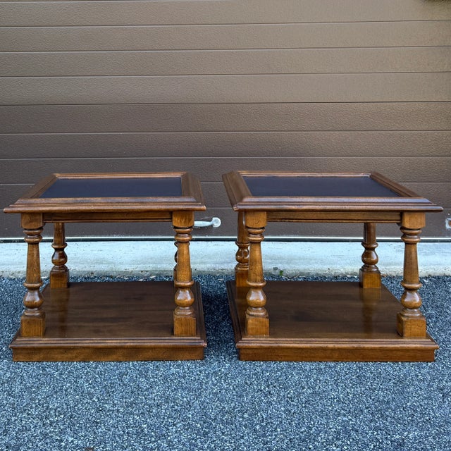 A pair of mid 20th century Ethan Allen Classic Manor collection 2 tier side tables or bunching tables having inset faux...