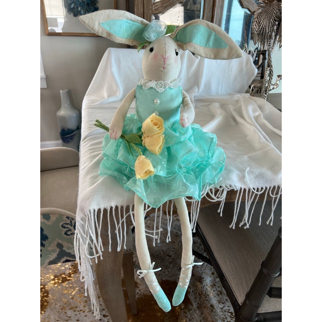 Cute ballerina bunny holding yellow flowers. This little girl has a weighed bottom so she can sit on the shelf edge as...