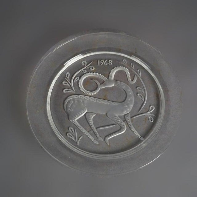 Twelve-Piece French Lalique Commemorative Crystal Plate Set 20th C; Dates from 1965-1977. Measures- 8.5''H x 8.5''W x...