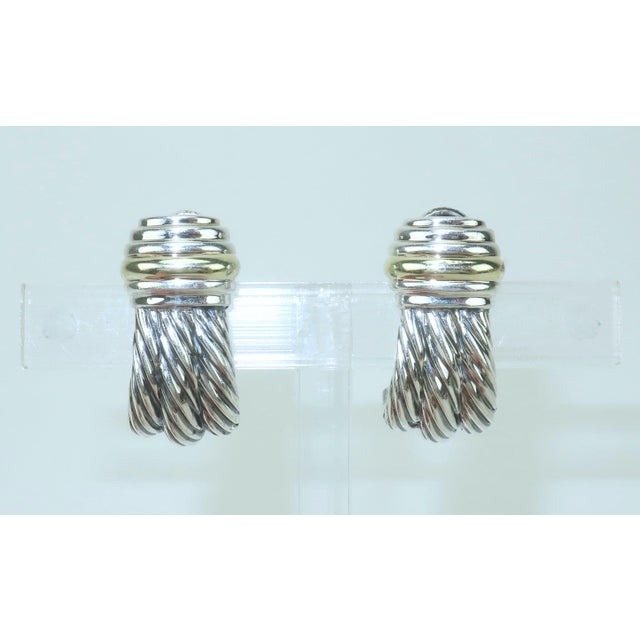 Classic and chic! David Yurman sterling silver earrings with 14K gold accent in a cable style design that takes on the...