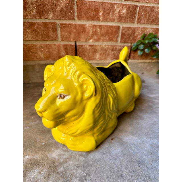 Yellow porcelain Ceramic Lion Planter A bold ceramic lion planter finished in a vibrant, high-gloss yellow glaze. The...