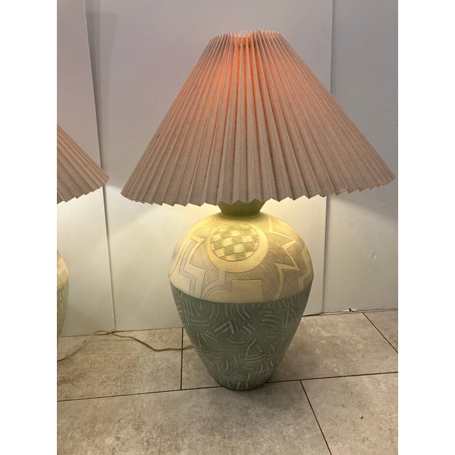 This pair of lamps was made in California by the Casual Lamp Co. in 1988. The textural linen shades and painted finials...