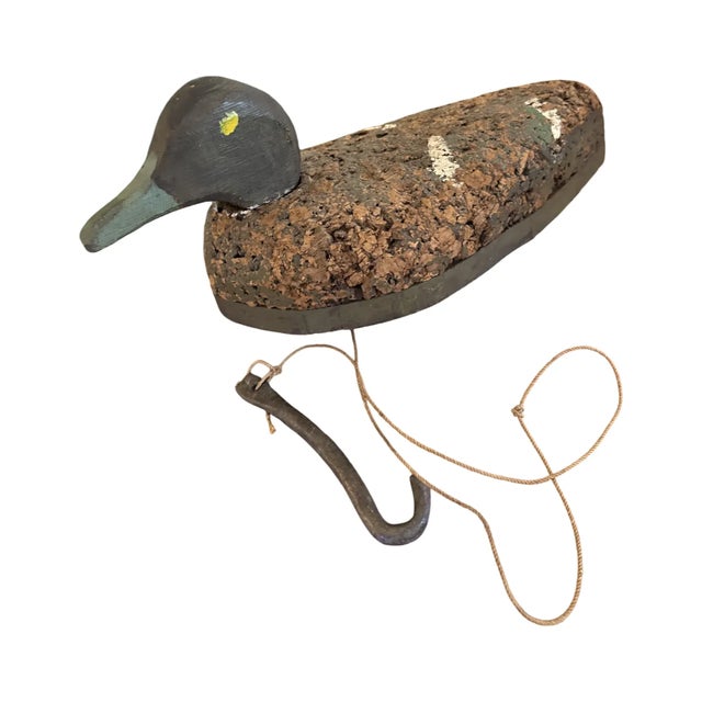 An authentic vintage working duck decoy featuring a hand-carved wooden head, genuine cork body construction, and its...