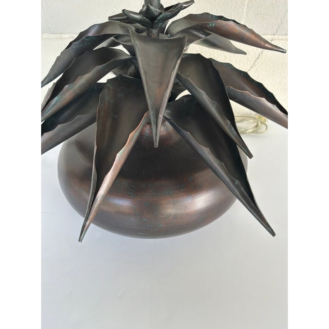 Sculptural Agave Metal Lamp Aged Bronze Finish. Layered in metal leaves on top of round base with dark finish. Showroom...